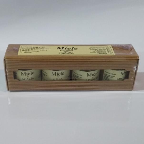 Vista frontale della scatola portavasetti in cartoncino avana con quattro vasetti da 50 grammi di miele assortito